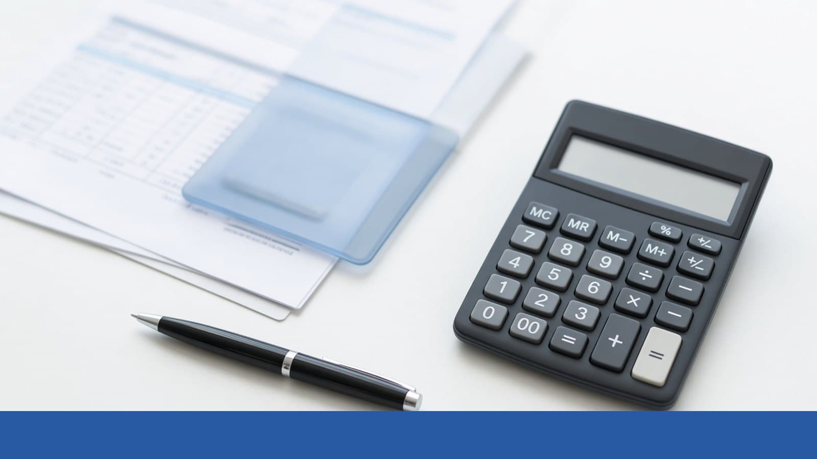 Calculator and pen on medical billing papers